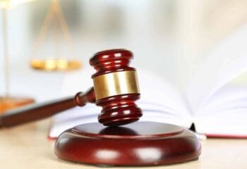 Wooden judges gavel on wooden table, close up