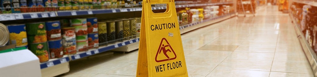 caution wet floor sign in a grocery store to help prevent slip and fall accidents