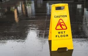 caution wet floor sign on a slippery floor, los angeles slip and fall lawyer