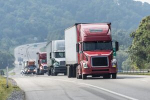 line of semi trucks on the highway
