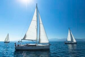 sail boats sailing on a clear water
