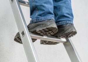 close up of a person standing on a ladder