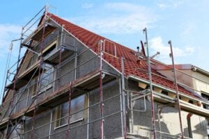 construction site with scaffolding around a house