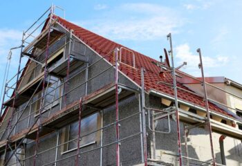 construction site with scaffolding around a house