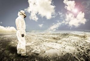 person in protective gear looking over a desolate area