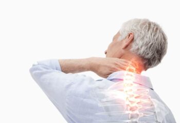 man holding the back of his neck with his spine highlighted