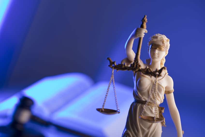 lady justice with gavel and open law book