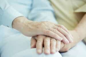 close up of seniors hands holding each other