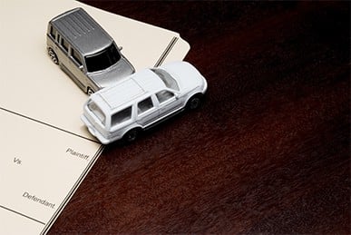 two toy cars demonstrating a car accident