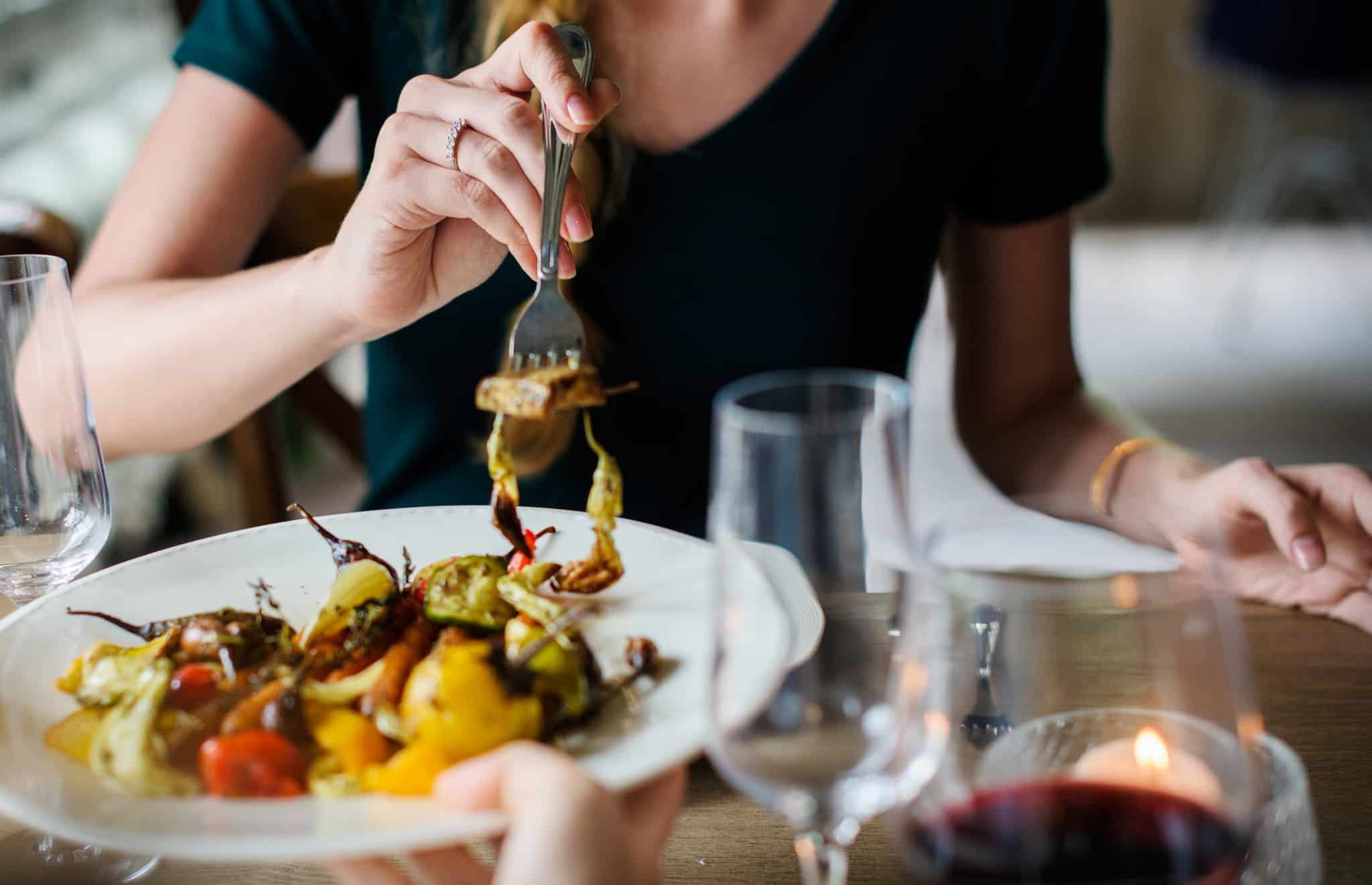woman eating food at a restaurant