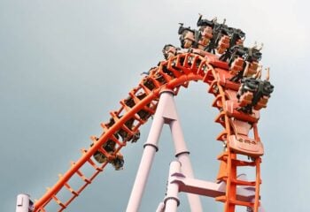 people riding an orange roller coaster; lawyers for injuries after roller coaster accidents