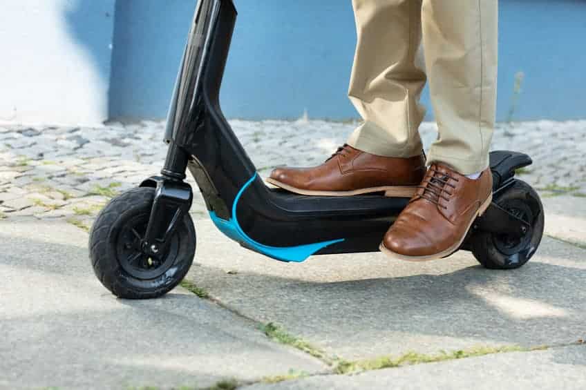 close up of a person's legs on an electric scooter
