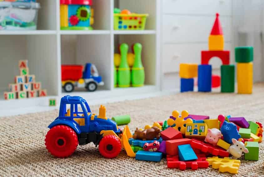 Children's playroom with plastic colorful educational blocks toys. Games floor for preschoolers kindergarten. interior children's room. Free space. background mock up