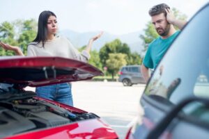 Woman and Man angry after a car crash with a rear ending