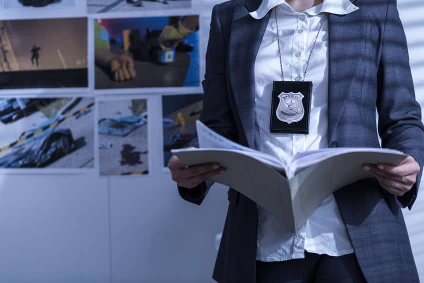 Police woman reviewing files and documents