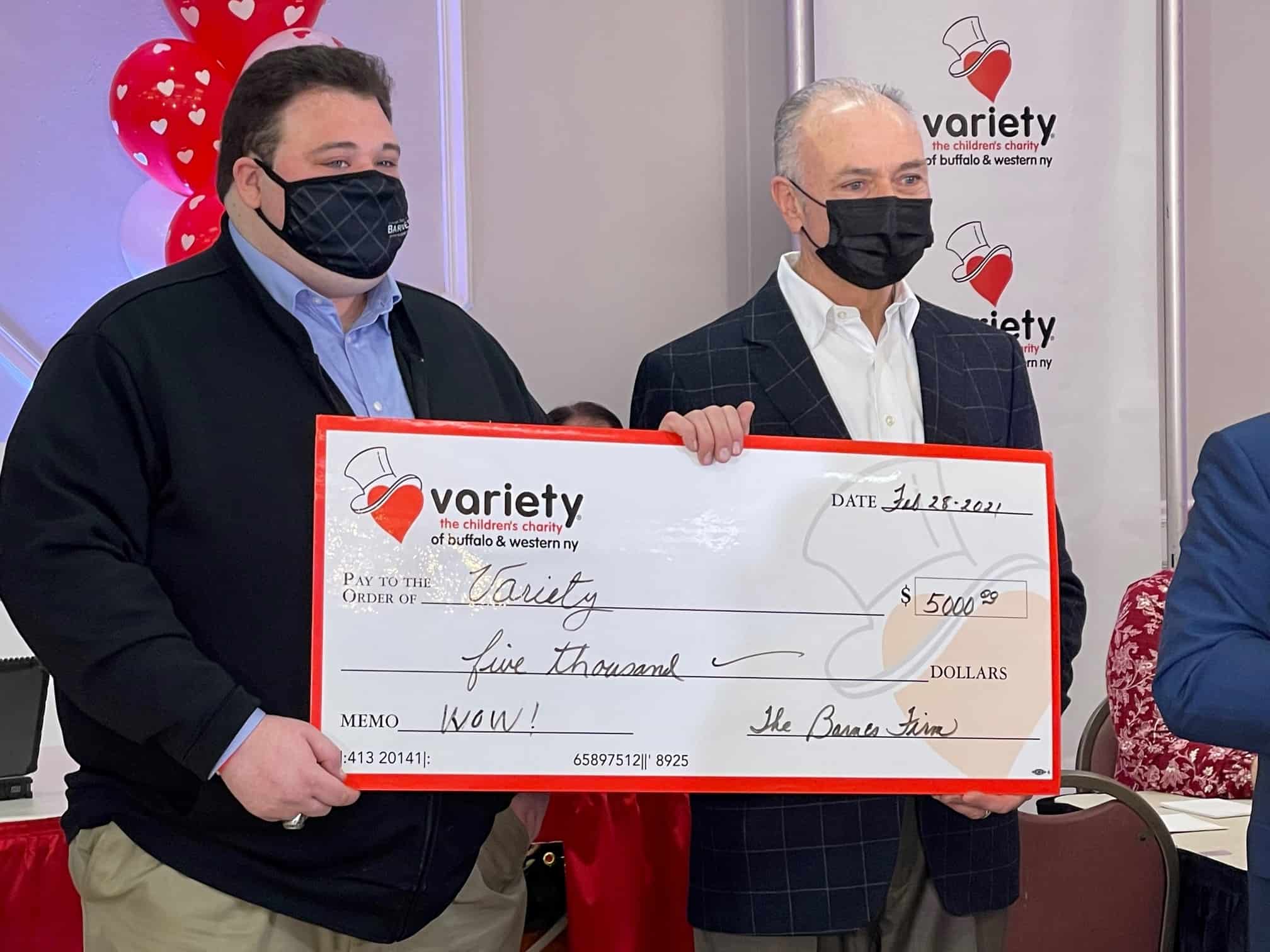 Rich Barnes handing off a $5000 check to variety, the children's charity of buffalo and western ny