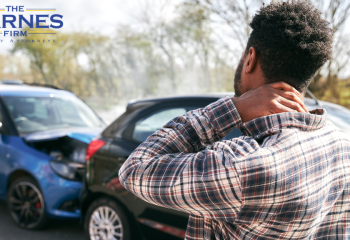 Young man rubbing neck in pain after whiplash injury from car accident