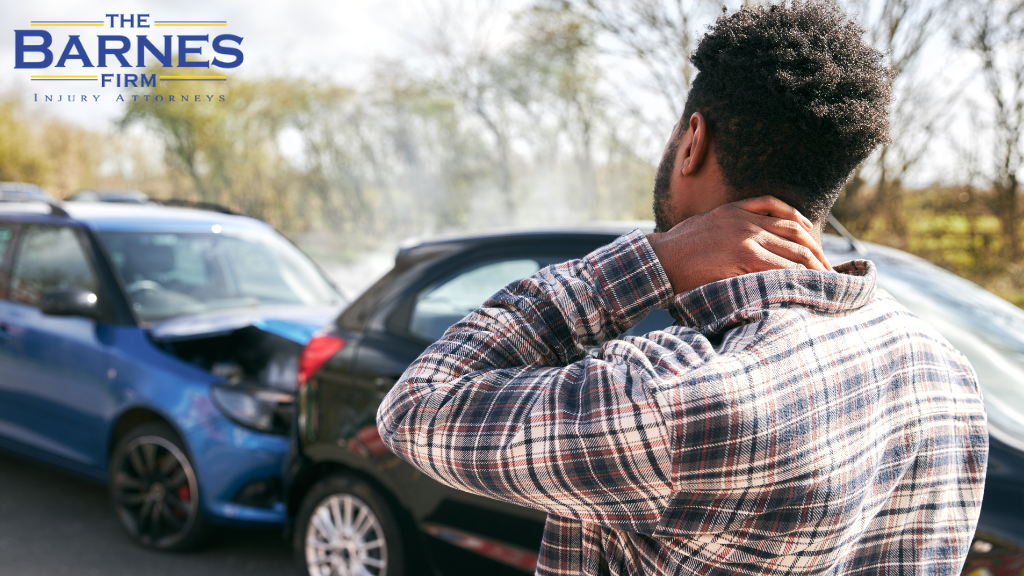 Young man rubbing neck in pain after whiplash injury from car accident