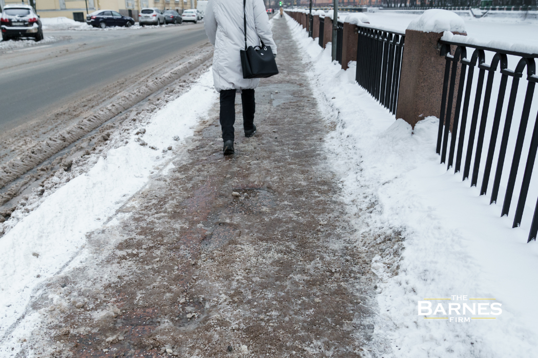 Ice and snow accumulation on a Buffalo sidewalk creating unsafe walking conditions
