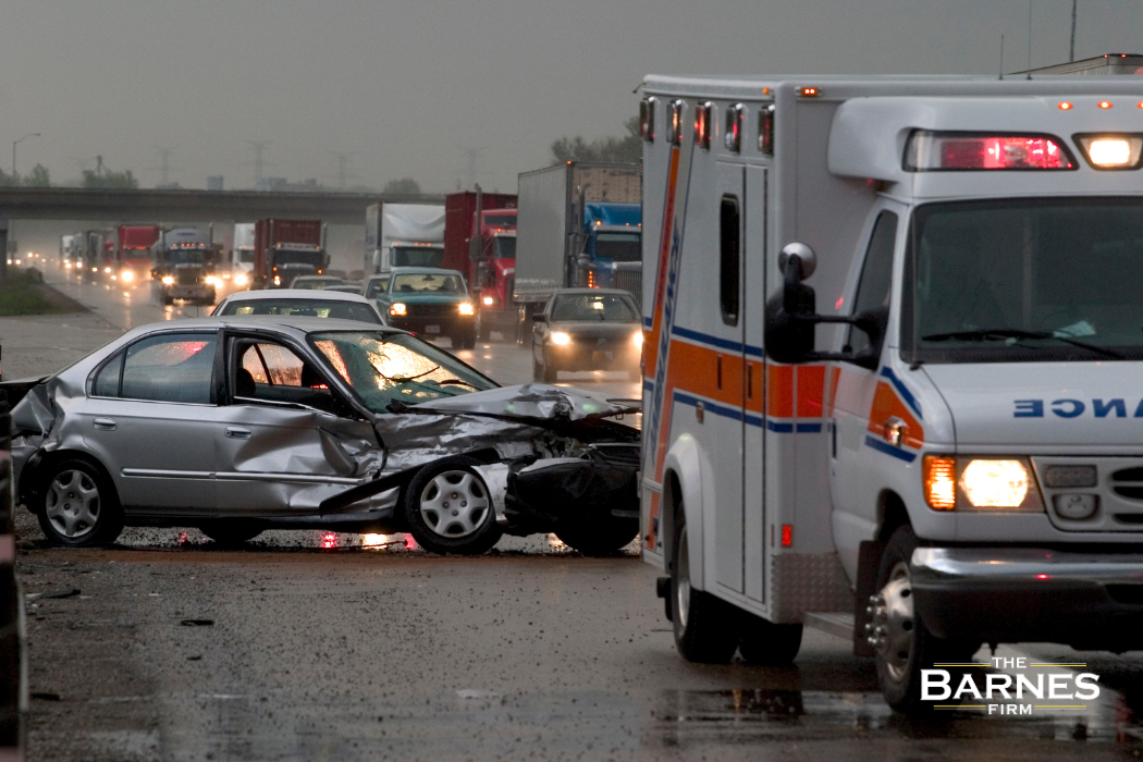 Ambulance helping an injury victim after a car accident